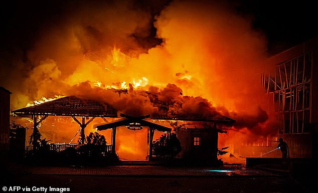 A rescue worker tries to put out a fire following a Russian missile attack in Mykolaiv, Ukraine