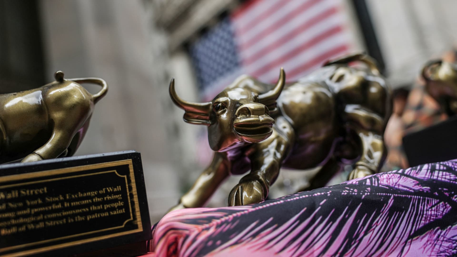 A small replica of the Charging Bull statue is seen on a street vendor stall outside the New York Stock Exchange on July 11, 2025.