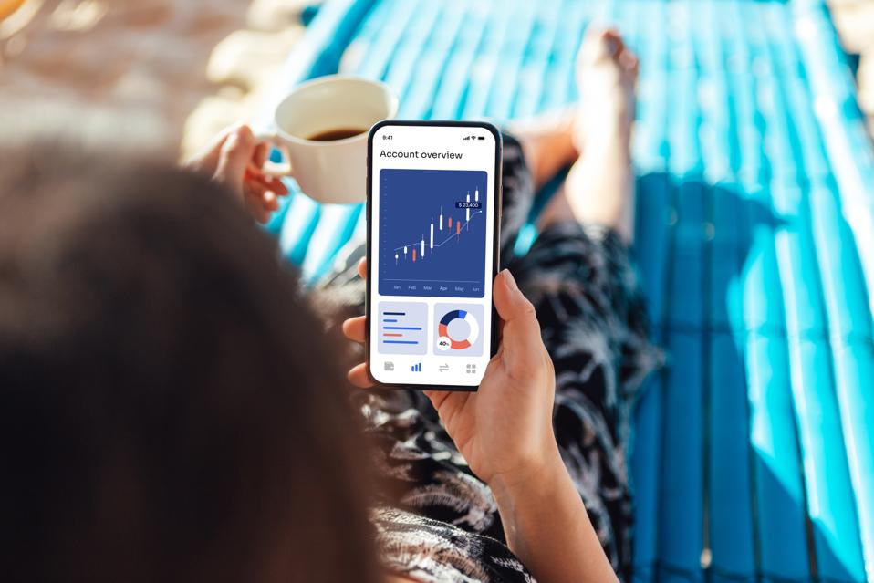 Young woman checking online bank account with smartphone