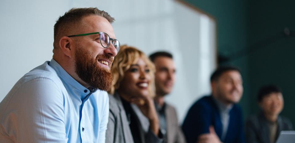 Businesspeople Listening To A Presentation In Their Office