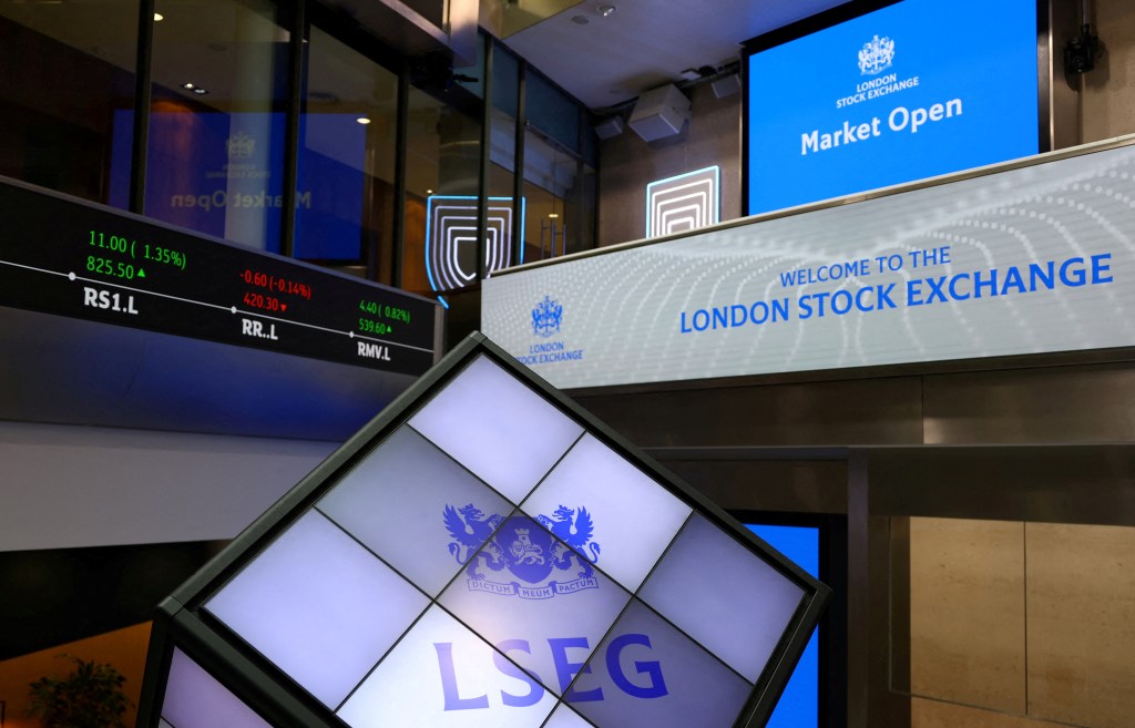 London Stock Exchange interior with market data displays.