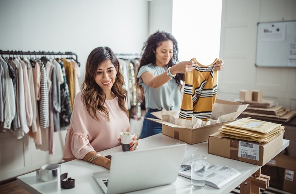 Two women working at a clothing retailer