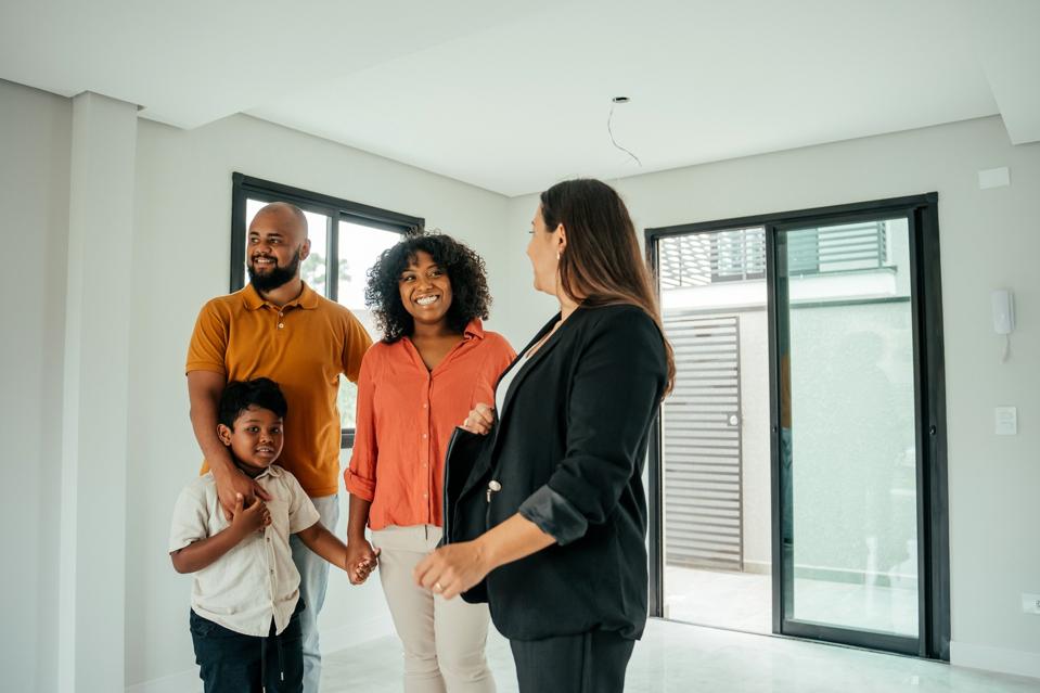 Couple with a child talking to the real estate agent