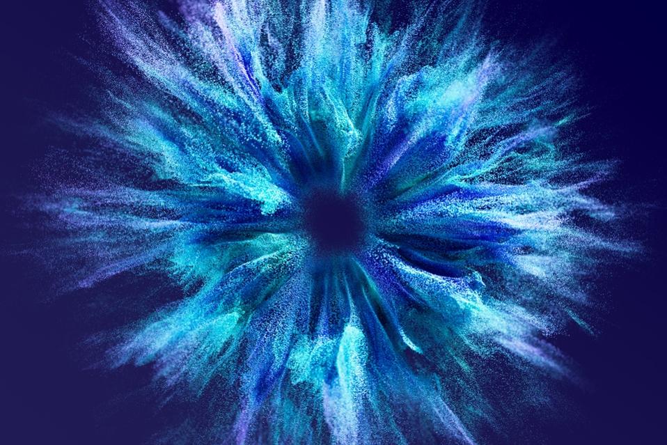 Colorful particles exploding from the center creating a futuristic effect