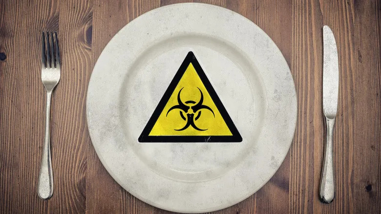A biohazard warning label on a white dinner plate.
