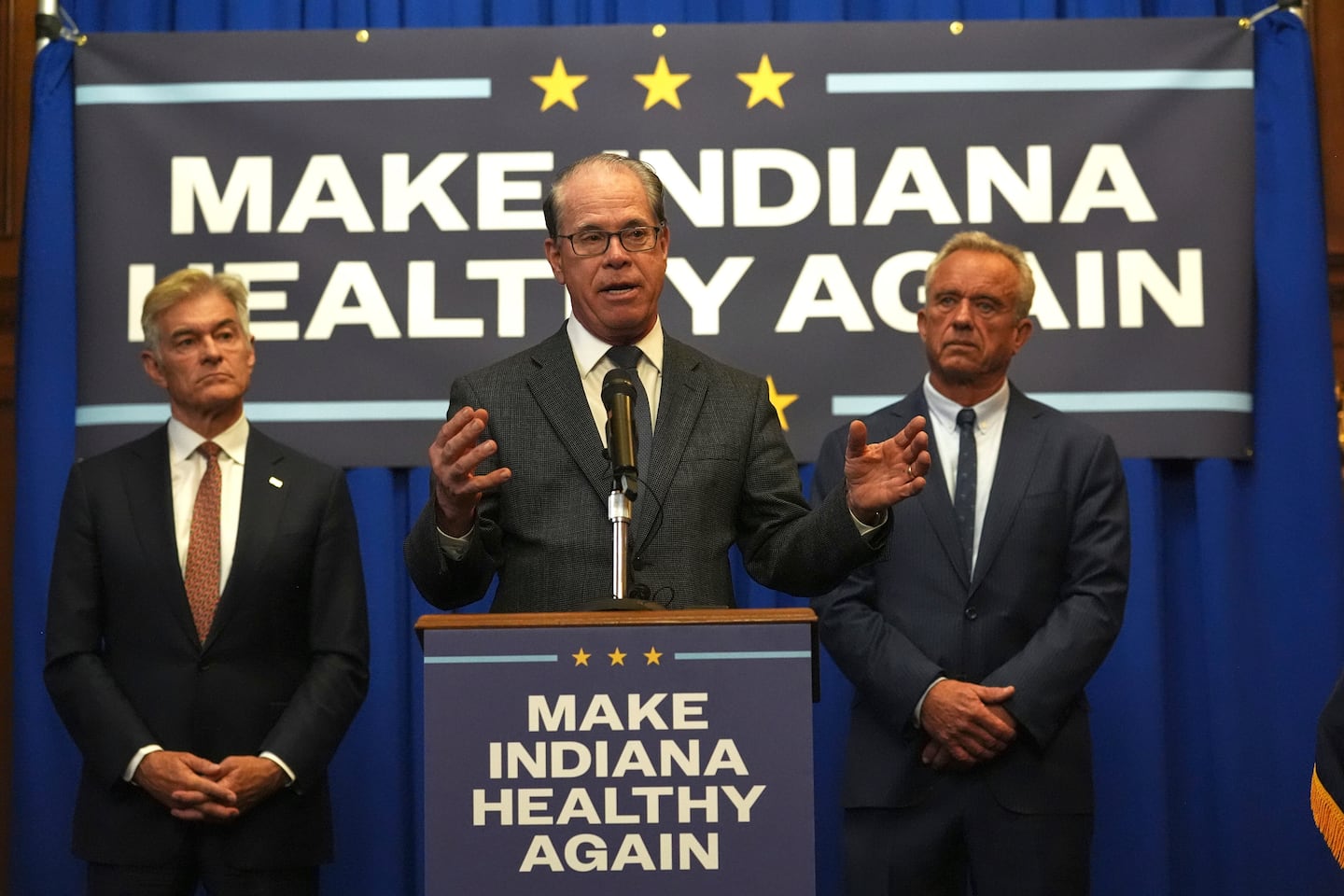 Indiana Governor Mike Braun is joined by Health and Human Services Secretary Robert F. Kennedy, Jr, right, and Centers for Medicare and Medicaid Services Administrator Dr. Mehmet Oz during a news conference in Indianapolis, April 15, 2025.
