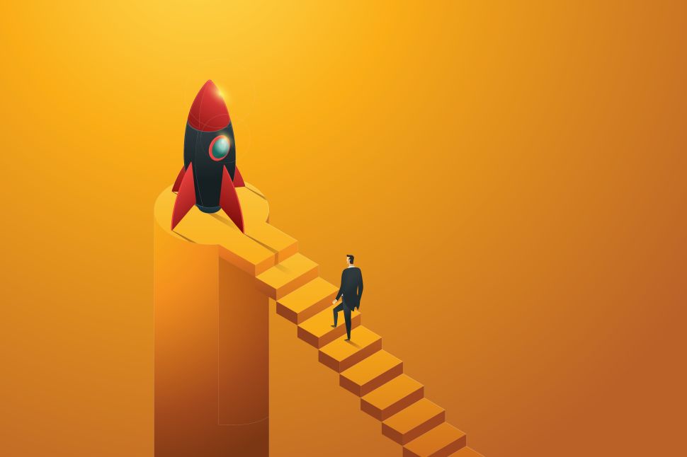 Businessman walking up stairs to a rocket