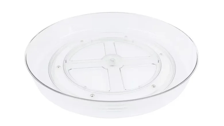 A clear plastic lazy Susan-style turntable