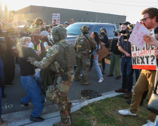 Kat Abughazaleh, left, candidate for Illinois' 9th District, is confronted by federal agents as protesters block a vehicle from entering the Immigration and Customs Enforcement facility in Broadview on Sept. 19, 2025. (Stacey Wescott/Chicago Tribune)