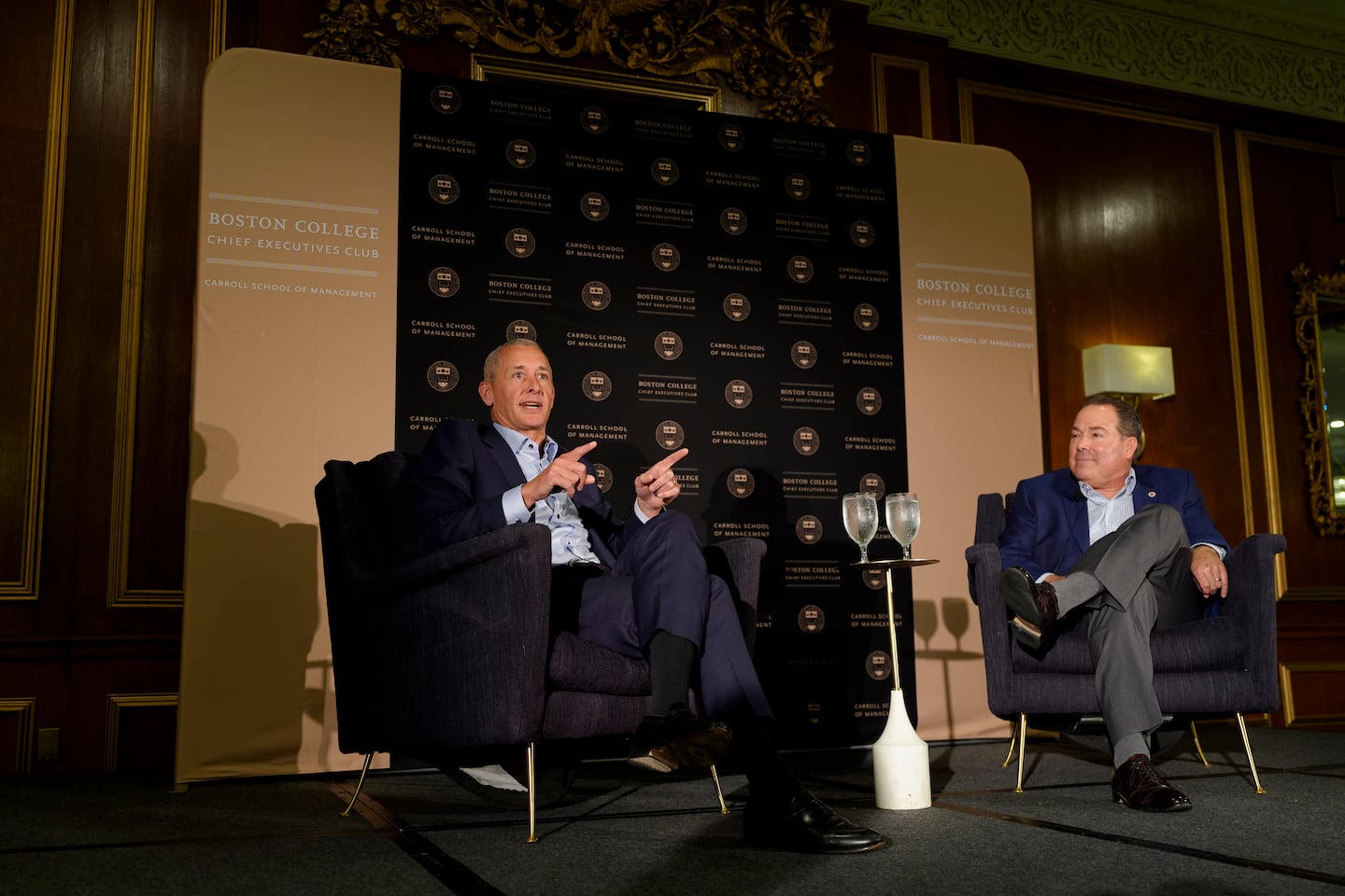 M&T chief executive Rene Jones and Eastern Bank executive chair Bob Rivers talk at the Boston College Chief Executives Club on Wednesday.