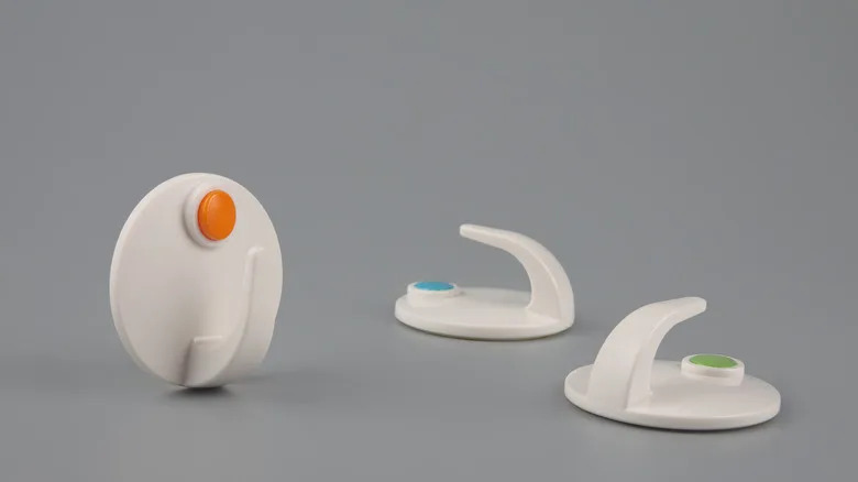 plastic utility hooks sit on a gray background