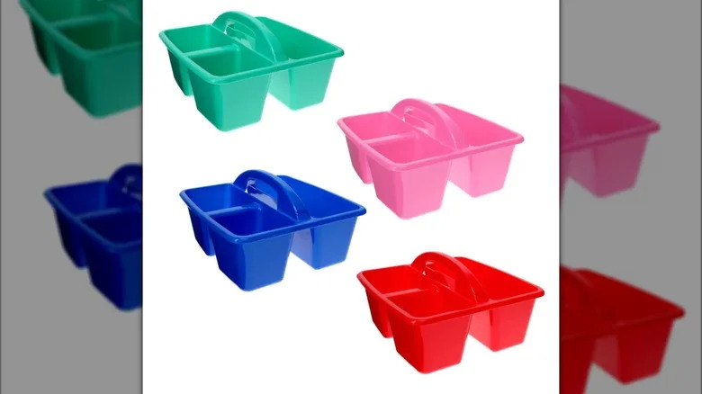 Four plastic storage caddies -- one blue, one green, one pink, and one red -- each with three storage compartments and a handle