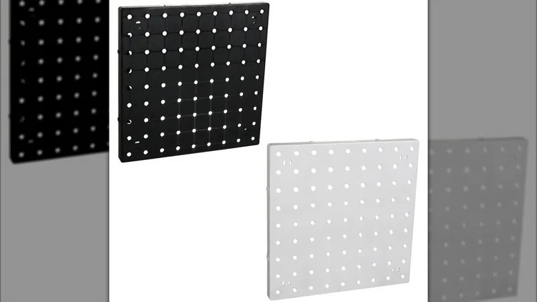 A white, square peg board and a black, square peg board