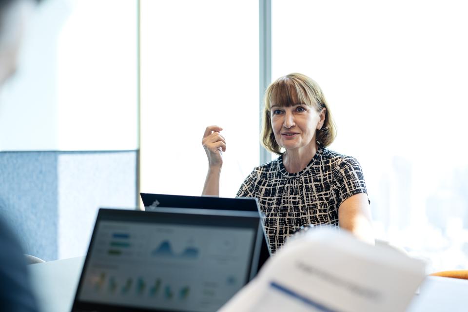 Aligning Risk Management with Business Strategy to Enhance Confidence for Your Business. Senior Business Executive in business performance meeting to determine direction with partner in a modern business office. Business Relationship, Corporate Business.