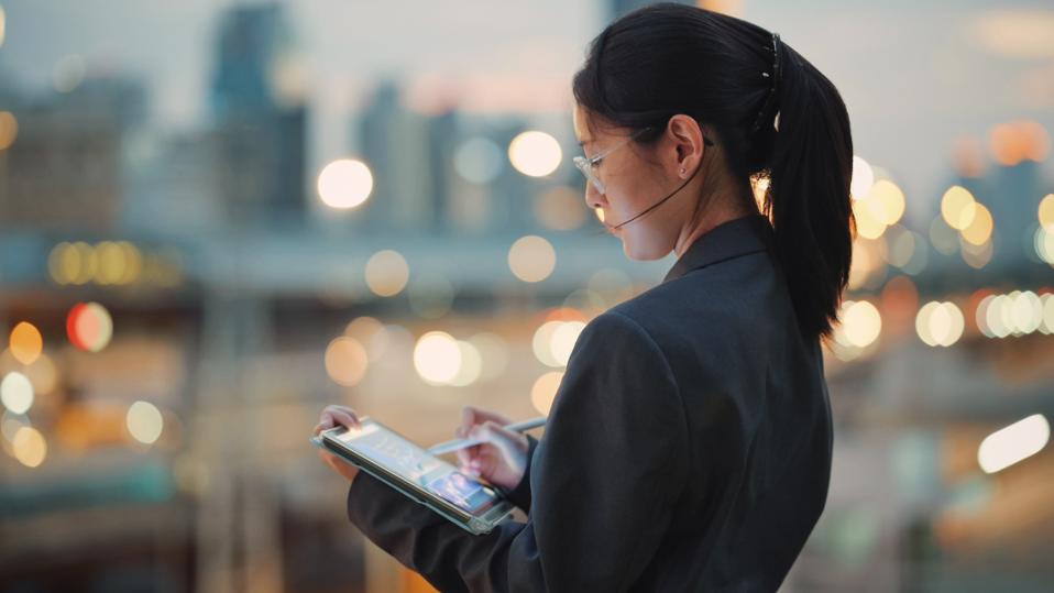 Global investor coding business AI tools on a digital tablet showcasing the creation of software solutions for enterprisesuse of AI in business 2025