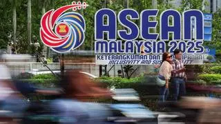 People take photos next to the ASEAN logo ahead of the 47th ASEAN Summit, in Kuala Lumpur, Malaysia, October 24, 2025.