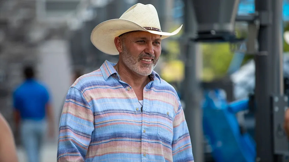 Steve McBee Sr. wearing a cowboy hat and a flannel shirt.