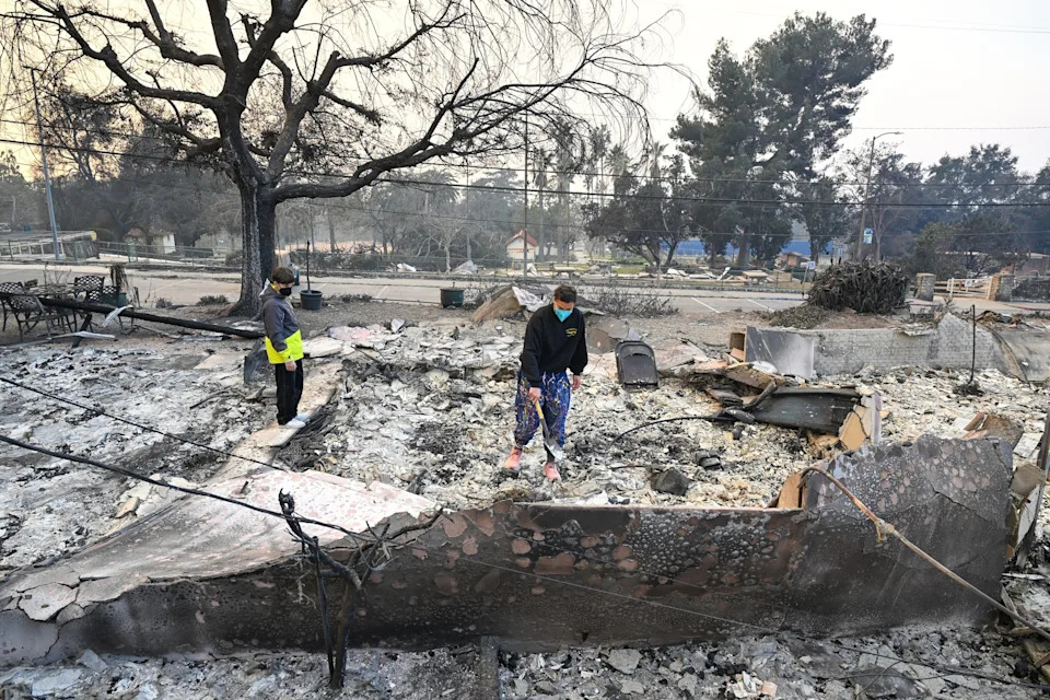 Tayfun Coskun/Anadolu via Getty Images - PHOTO: People inspect the area among the rubbles of burnt houses during Eaton wildfire in Altadena of Los Angeles County, California, United States, January 9, 2025.