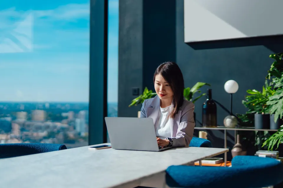 Young Asian businesswoman working with laptop in a modern and stylish office