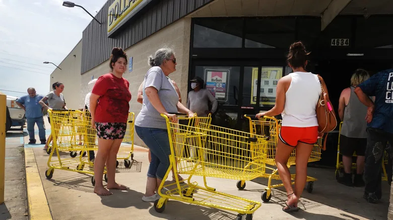 People waiting in line to shop at a dollar store