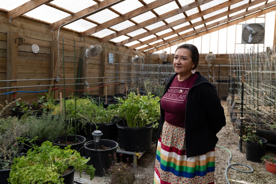 Natalie Hand, field director at Conscious Alliance, explains the produce grown inside the walipini near Pine Ridge, South Dakota, on November 4, 2025.