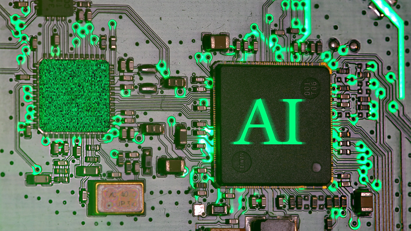 A close-up image shows a computer chip labeled “AI” connected to a circuit board illuminated with green light. Photo: Immo Wegmann / Unsplash