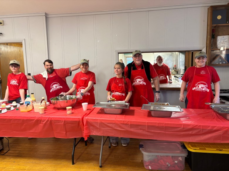 Jesse Levesque, Scoutmaster Josh Levesque, Asst Scoutmaster Belinda Backstrom, Maddie Pelletier, Asst Scoutmaster Bob Hirschey, Asst Scoutmaster Jon Whitney, and in kitchen, Dax Castiglioni serve up plates of spaghetti. 