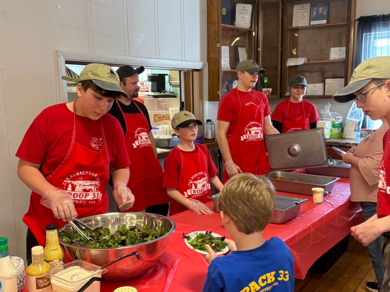 Grant Johnson, parent Sam Mullen, Wally Woodhouse, Nick Roberts and Bella Erickson serve up spaghetti to residents.