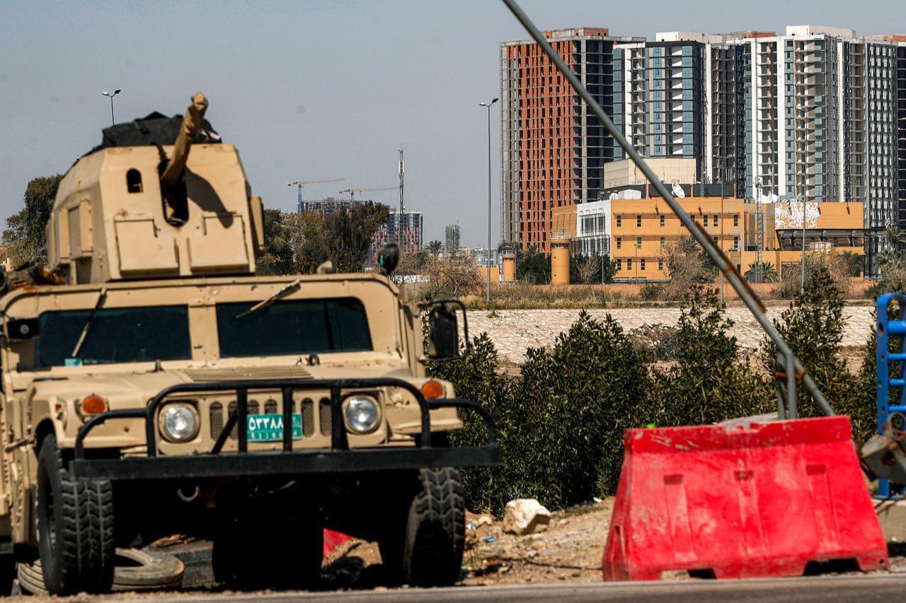 An Iraqi army armoured humvee vehicle is deployed near the banks of the Tigris River to protect the US Embassy headquarters (R) in Baghdad's fortified "Green Zone" on March 18, 2026. (AFP Photo)