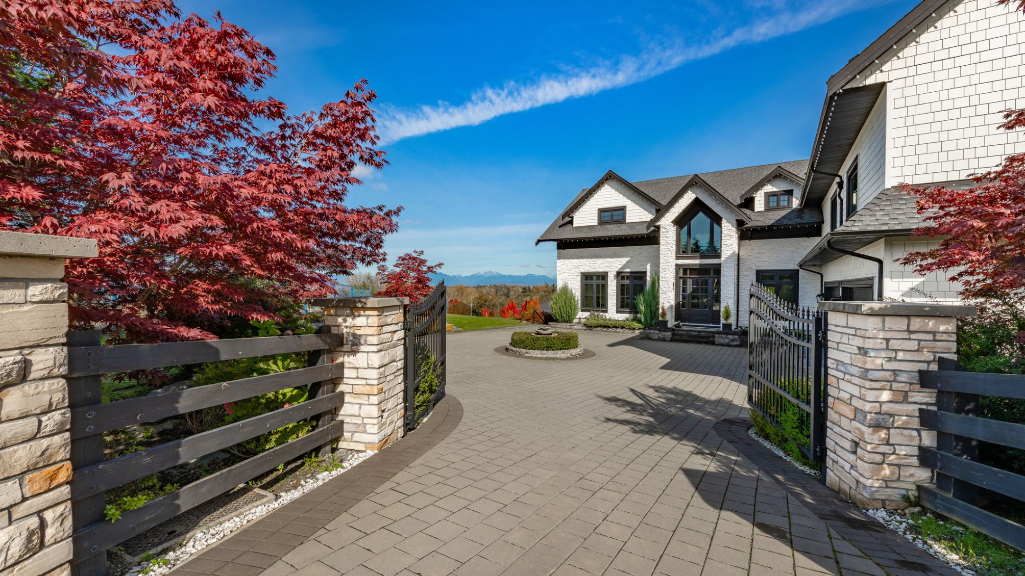 Exterior photographs of the front entrance of a large gated estate-style home