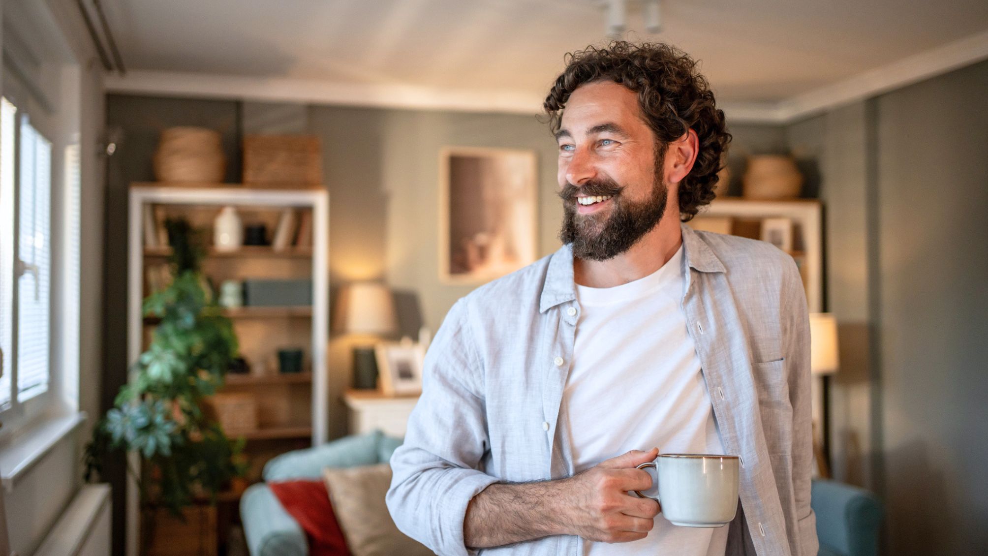 A man enjoying a cup of coffee at home.