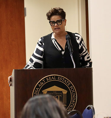 Virginia Teachey standing at a podium