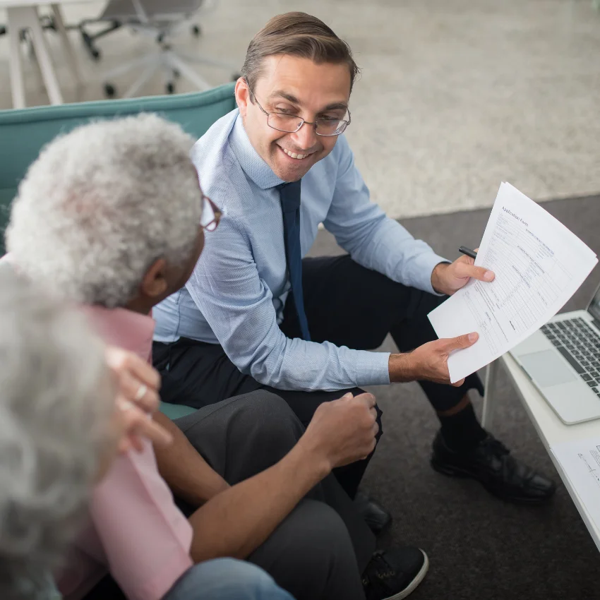 boomer couple meeting with a financial advisor to invest their money
