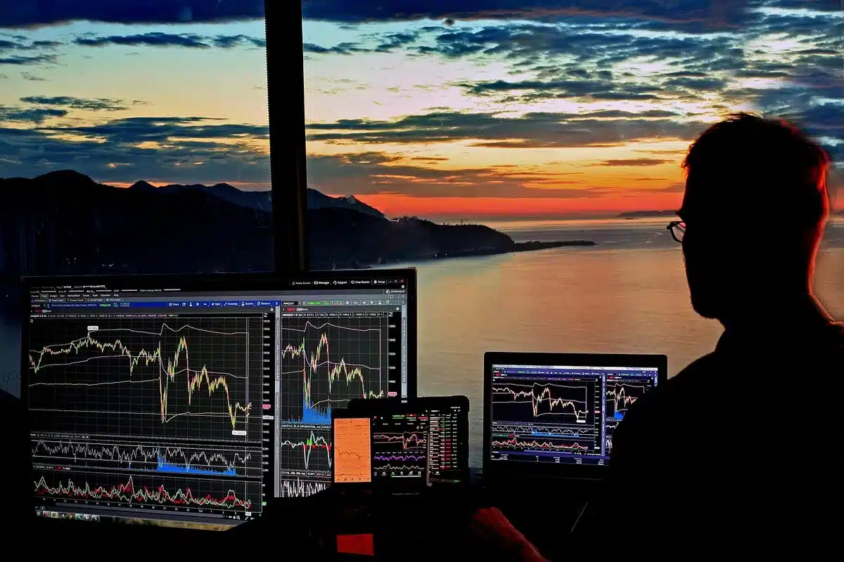 anonymous traders watching currency screens in a dim trading room, screens showing FX charts and numbers blurred